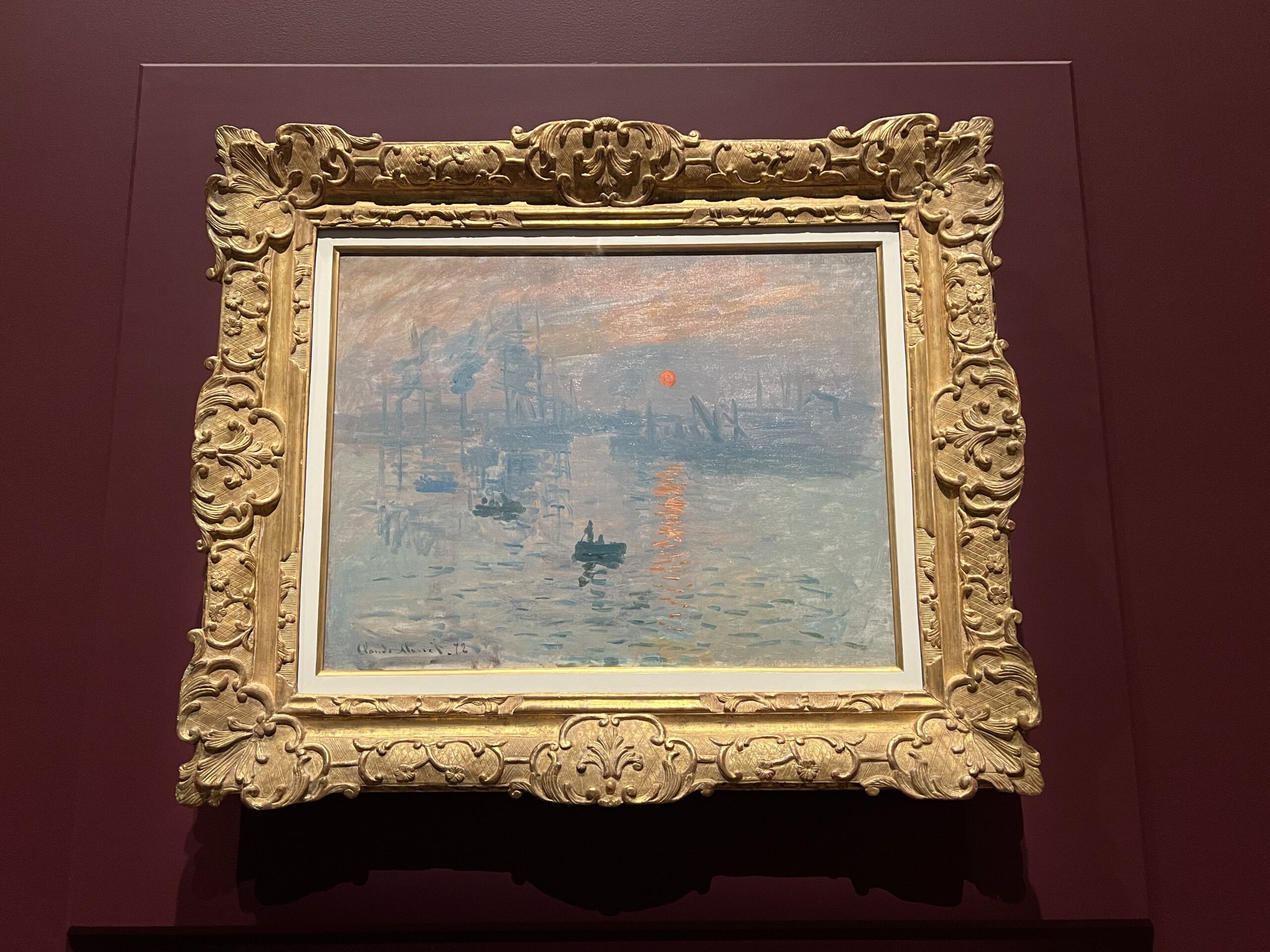 Monet Sunrise painting in a museum frame